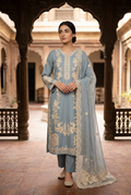 AI-modelled courtyard view of dusty blue embroidered suit