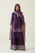 Purple embroidered suit styled in an ivory studio